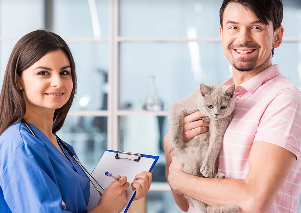 Pet owner with a happy cat at a professional care facility